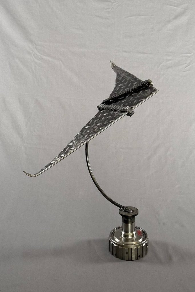 Fly — a trophy welded from reclaimed automotive parts